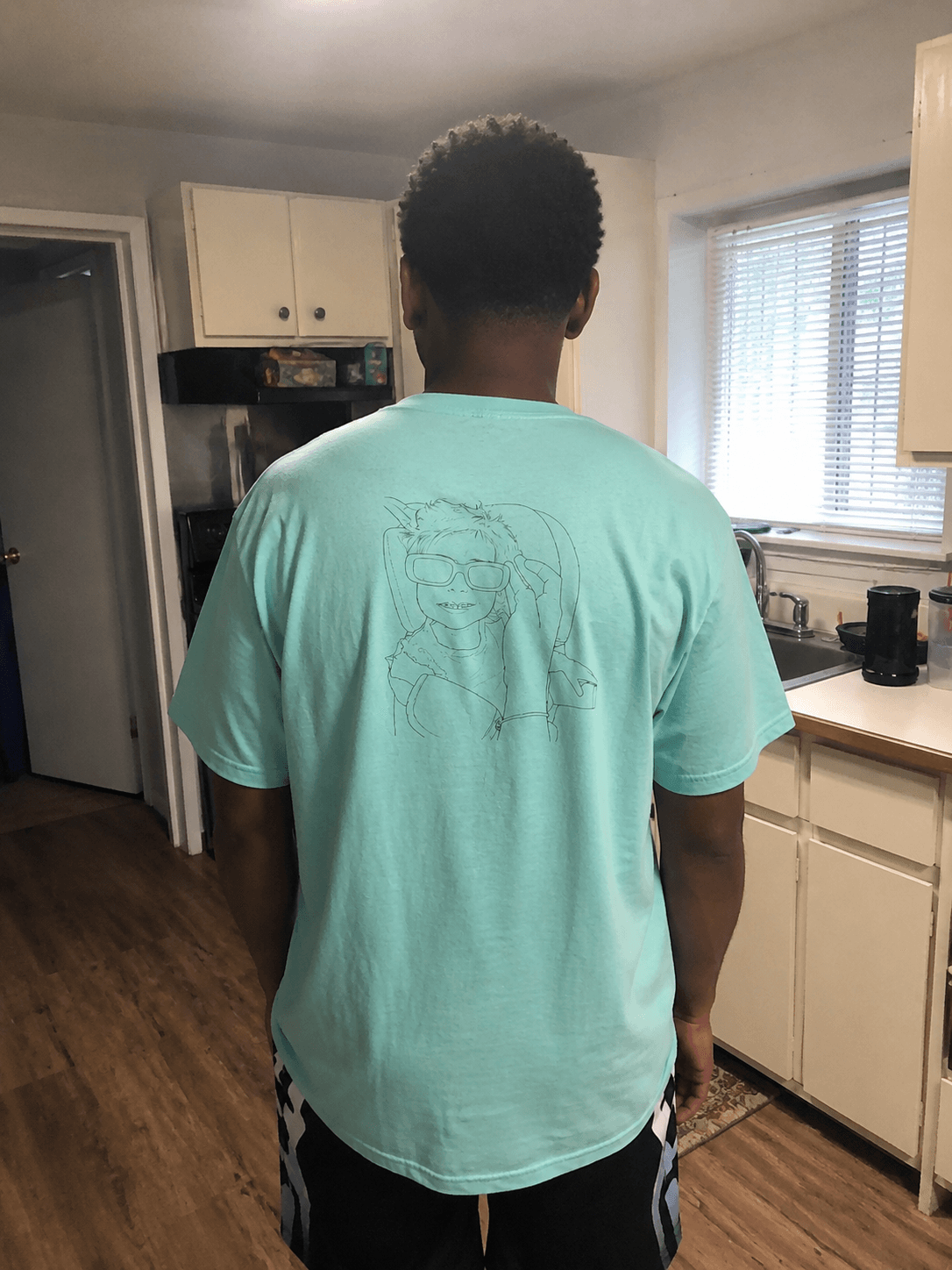 Kwame wearing their custom Proud Daddy shirt